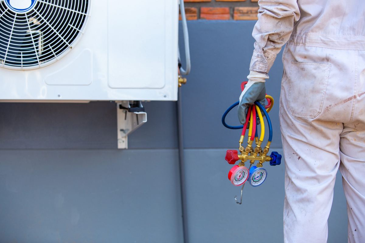 HVAC technician repairing an air conditioning unit